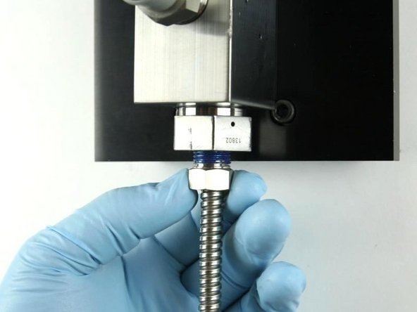 Thread in the high-pressure tubing to the bottom of the high-pressure gland fitting.