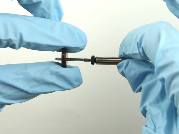 Slide the  stainless steel back-up ring on to the valve stem point with the chamfer side towards O-ring.