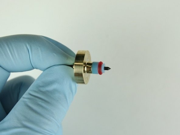 Slide the high-pressure valve seal onto the needle point with the O-ring away from the needle bearing.