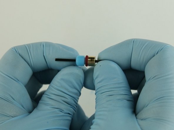 With the O-ring down, slide the high-pressure valve seal onto the poppet stem behind the bushing stem.