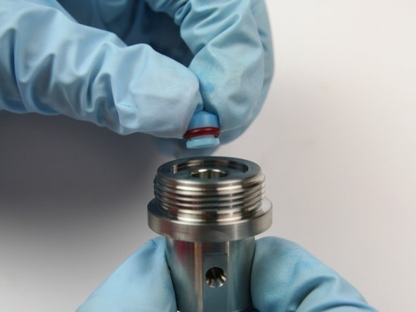 Put the high-pressure seal from the kit, with the O-ring down, into the cavity of the seal half of the swivel housing.