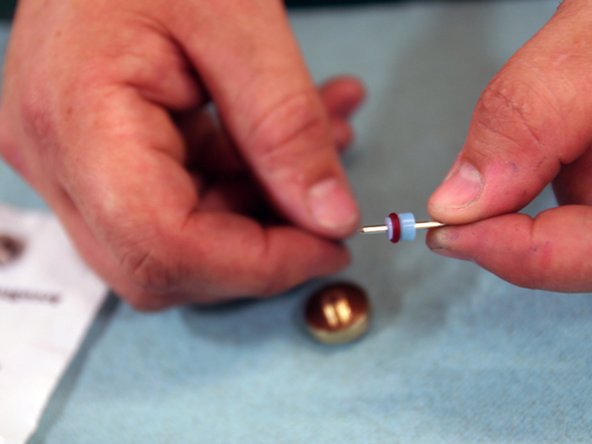 Insert Needle through HP Seal. Make sure the red o-ring is facing towards needle tip.