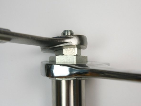 Loosen the hydraulic fitting from the adapter fitting using 1-1/4&quot; and 7/8&quot; wrench.