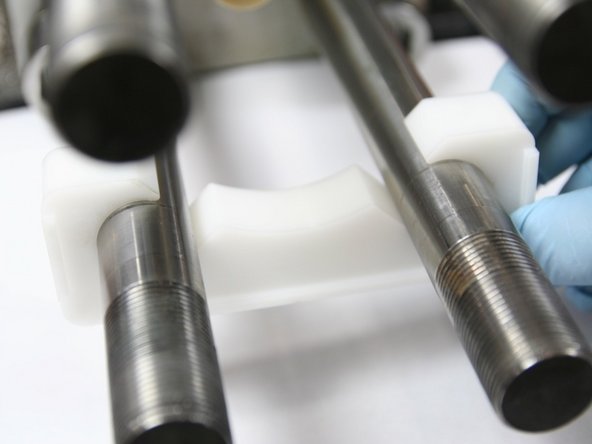 Place mounting cradle on bottom studs of intensifier with tabs toward outside of intensifier