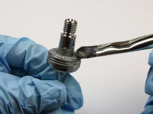 Apply lithium grease to the top of the thrust bearing.