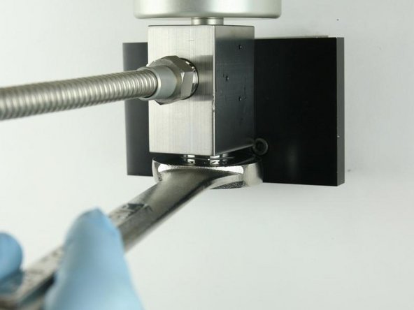 Tighten the high-pressure gland fitting using a 1-1/8&quot; wrench.