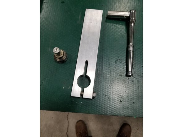 Insert check valve body clamp tool into bench vise