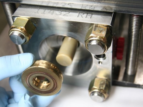 Flip over the bronze back-up and slide back onto the plunger.