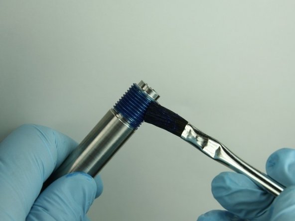 Reapply Blue Goop to the threads of the nozzle tube.