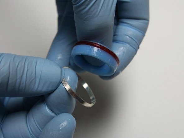 Put the hoop with the sharp (tapered) end down onto the back of the seal.