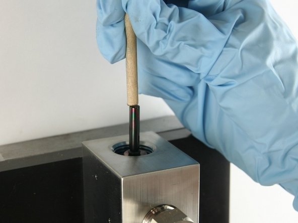 Push the valve stem with the dowel until it bottoms out.