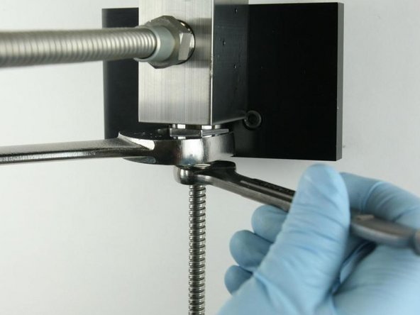 Tighten the high-pressure tubing to the high-pressure gland fitting using a 5/8&quot; and 1&quot; wrench.