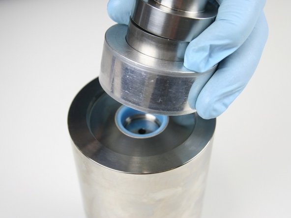 Hold the sleeve down against the cylinder with one hand to be sure it doesn't raise up while installing the hoop.