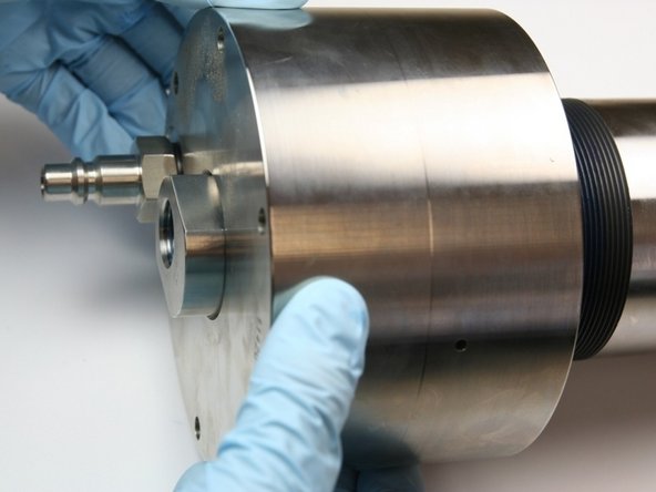 Thread the end cap onto the high-pressure cylinder.