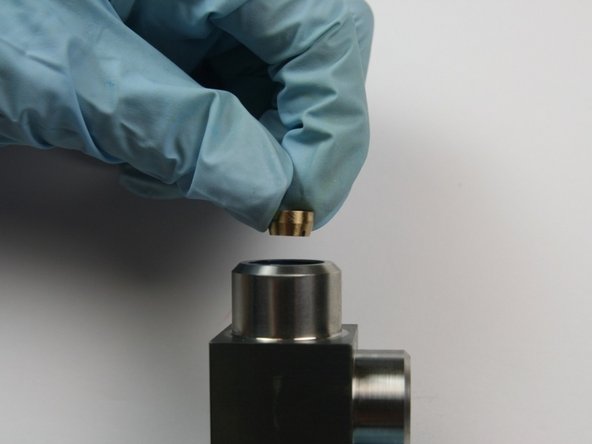 Put the back-up ring with the smaller face down into the non-lipped side of the swivel housing.