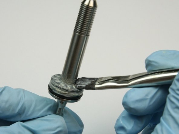 Apply a layer of lithium grease to the top of the thrust bearing.