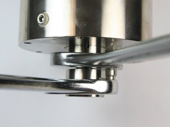 Tighten the outlet body into the check valve body using two 1-1/4&quot; wrenches.