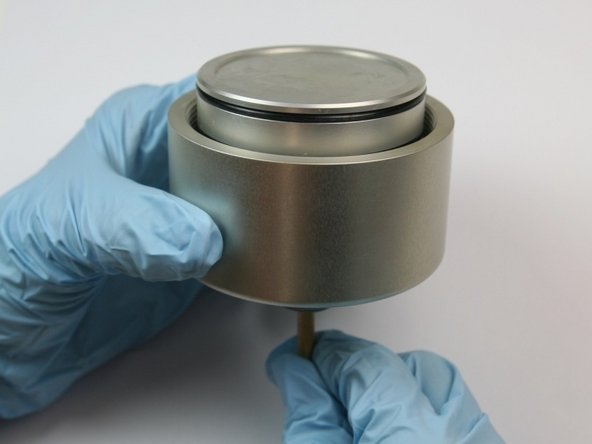 Push the dowel (included in the kit) through the hole of the threaded nipple onto the actuator housing to remove the piston.