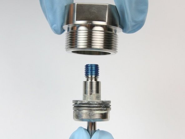 Put swivel shaft ,threads first, through bottom (thread side) of bearing half of swivel housing