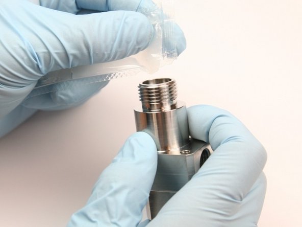 Apply a high vacuum grease to the  internal threads of the bleed down valve body.