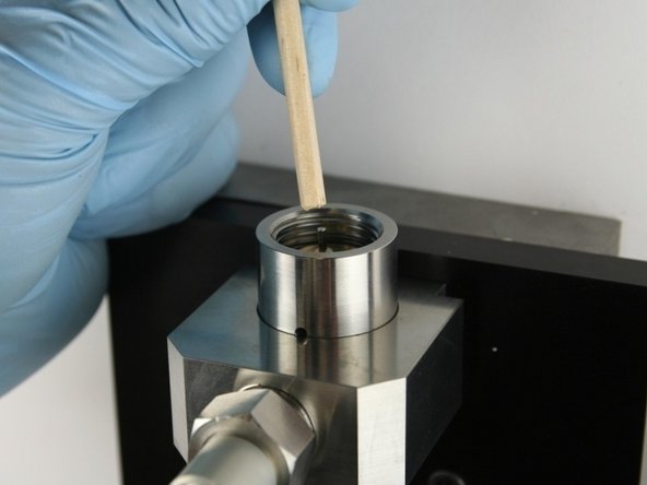 Use the dowel to push the needle into the valve body until the needle bearing bottoms out.