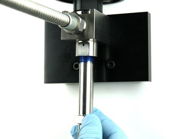 Thread the nozzle tube into the bottom of the valve body.