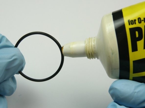 Apply a layer of O-ring lube to the medium sized O-ring.