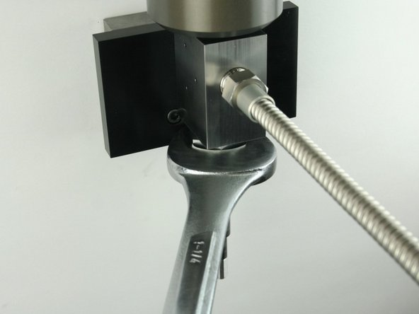Tighten the high-pressure gland fitting using a 1-1/4&quot; wrench.