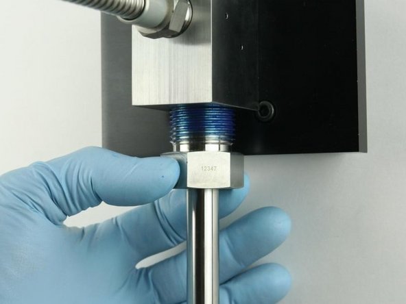 Thread the high-pressure gland fitting into the bottom of the valve body.
