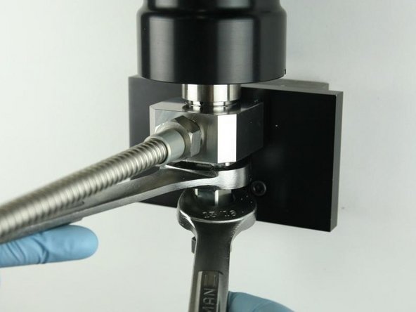 Tighten the adapter into the valve body using a 1&quot; and 13/16&quot; wrench.