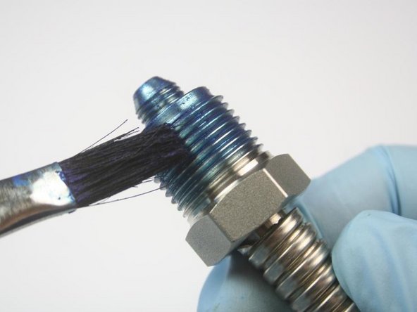 Apply Blue Goop to the threads of the high-pressure gland.