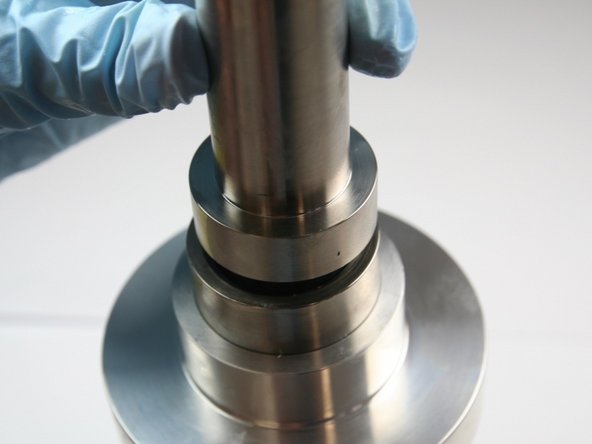 Push the hoop down into the sleeve with the blunt end of the installation tool.