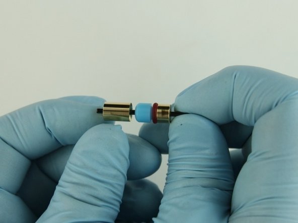 Put the back-up ring with the concave side towards the high-pressure seal on the poppet stem behind the high-pressure seal.