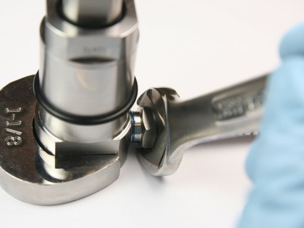 Tighten high-pressure gland into seal half of swivel housing with 1-1/8&quot; and 5/8&quot; wrench.
