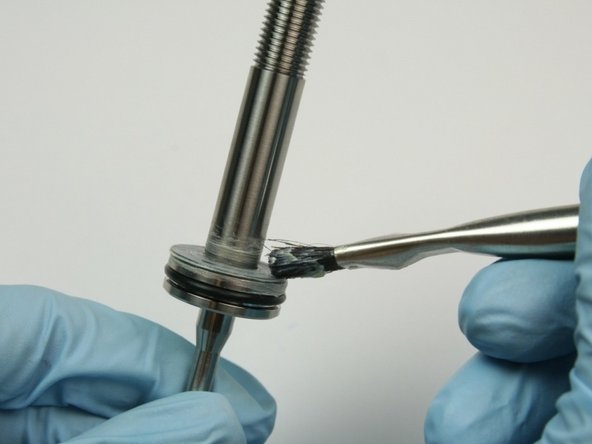 Apply a layer of lithium grease to the top of the thrust washer.