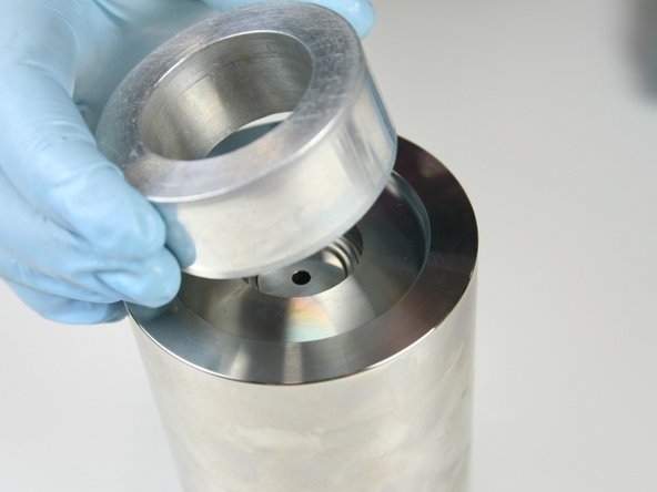 Put the locator tool onto the high-pressure cylinder.