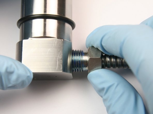 Thread high-pressure gland into seal half of swivel housing.