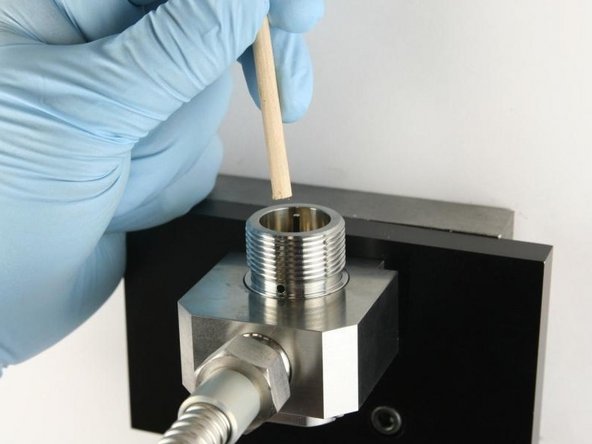 Use the dowel to push the needle in the valve body until the needle bearing bottoms out.