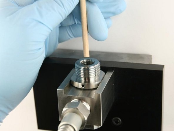Use the dowel to push the poppet stem down until the back-up ring is flush with the top of the bore.