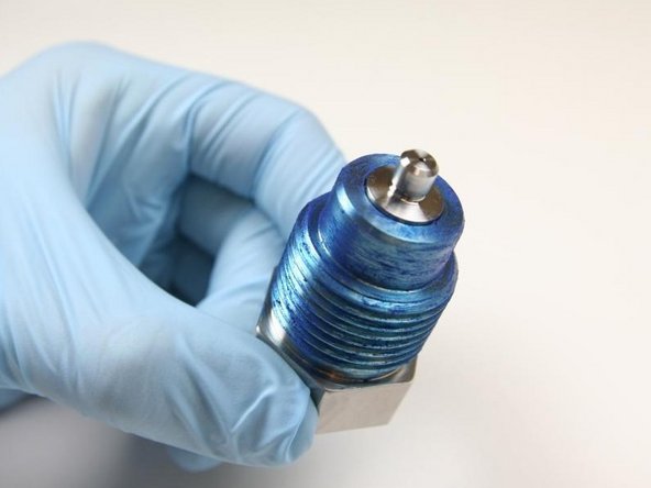 Put the seat into the top of the high-pressure gland fitting with the flat side towards the gland fitting.