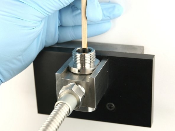 Use the dowel to push the poppet stem down until the back-up ring is flush with the top of the bore.