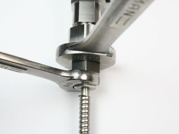 loosen gland nut from outlet fitting (connected to valve body) using 13/16" and 5/8" wrench
