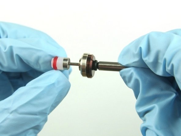 Slide the hoop and the high-pressure valve seal onto the valve stem with the hoop towards the brass back-up ring.