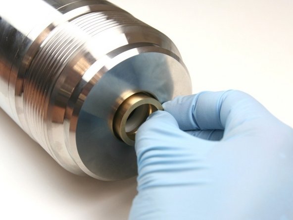 Put the brass packing follower into the high-pressure cylinder, behind the  dynamic seal back-up.