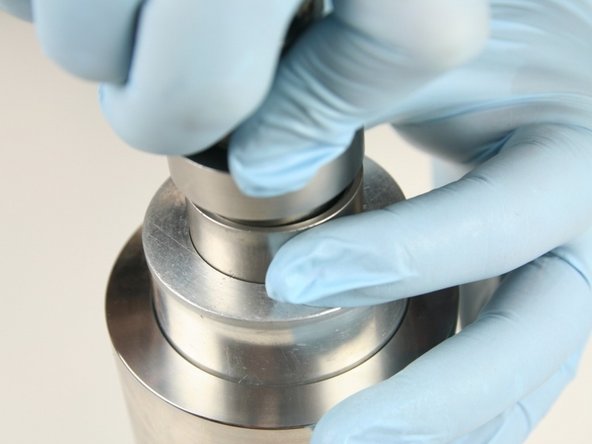 Put the non-stepped end of the push tool into the sleeve and press the high-pressure seal into the high-pressure cylinder until it bottoms out.