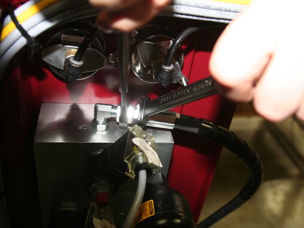 Install pressure gauge in new manifold.