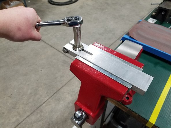 Use a 9/16&quot; socket to tighten the clamp onto the check valve body