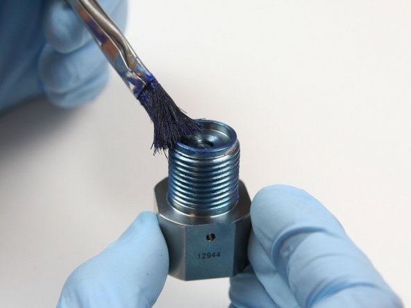 Apply a layer of Blue Goop to the external threads and the seat cavity of the outlet adapter.