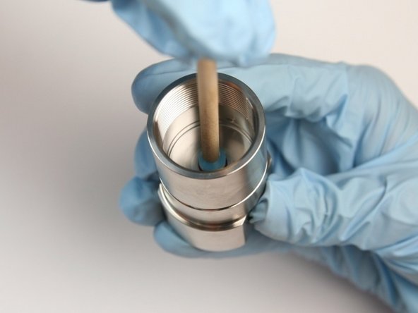 Put high-pressure seal, with the O-ring first, into the bore of the seal half of the swivel housing using a dowel.