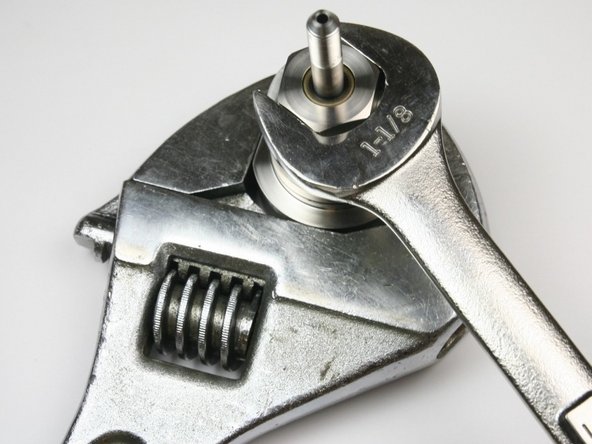 Tighten the bearing half of the swivel housing using a 1-1/8" wrench and a large adjustable wrench on the seal half of the swivel housing.
